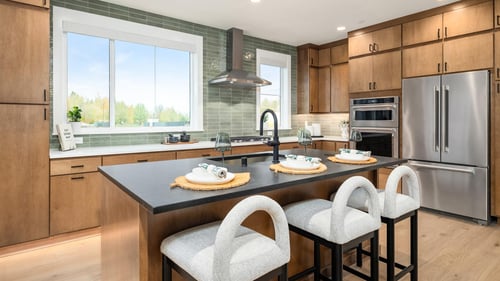 Acadian home design features a spacious kitchen with plenty of cabinet storage