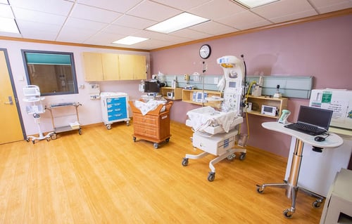 Another view of the nursery showing a bassinet, infant warmer and other equipment