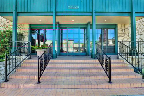 the entrance to a building with stairs and railings at Copa Ladeene Apartments, Torrance California