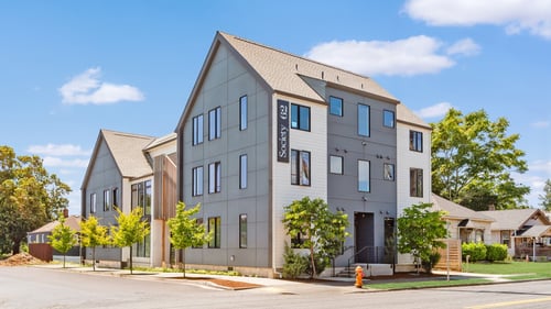A modern two-story building with a flat roof and a large front yard at Society 62 Apartments, Portland 97213