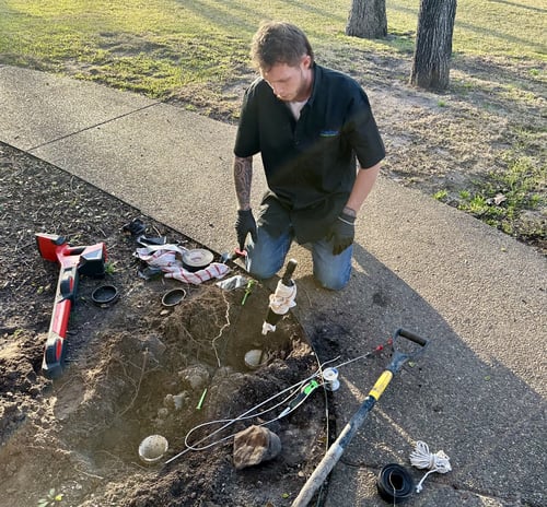 Bluefrog Plumbing + Drain technician inspecting plumbing in the Metro Fort Worth area