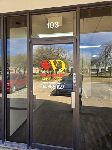 Front entrance of Southwest Voice & Data office with company logo on glass door.