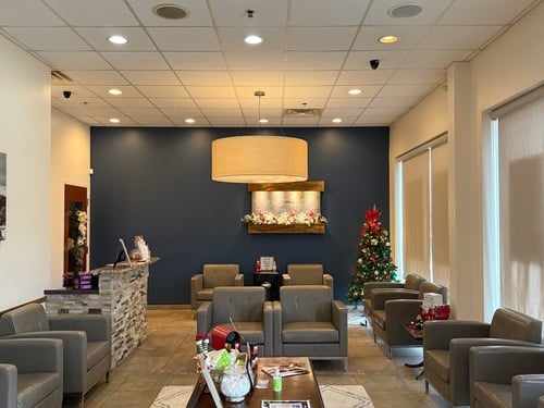Waiting area with Christmas decorations and comfortable seating at Hand & Stone Massage and Facial Spa Deptford NJ
