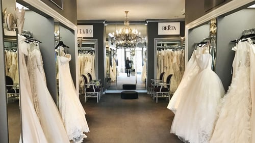 Mon Amie Bridal Salon showroom in Costa Mesa with designer wedding gowns and a crystal chandelier