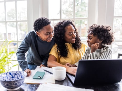 Family enjoying fiber internet at the kitchen table in [state].