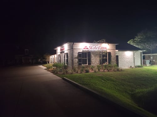 nighttime photo of the exterior of the Jake Jacobs - State Farm Insurance Agent office building with the State Farm wordmark lit up