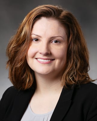 Dr. Crouch smiling in front of a gray background.