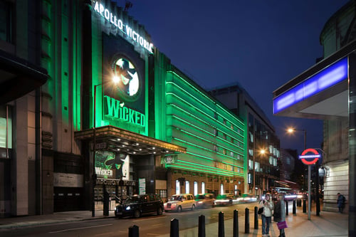 Side view of Apollo Victoria Theatre at night