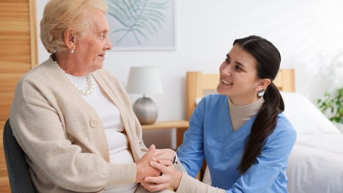 Home nurse embracing an older client