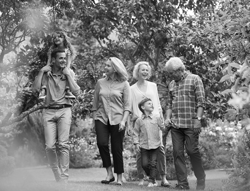 A multigenerational family walking through nature.