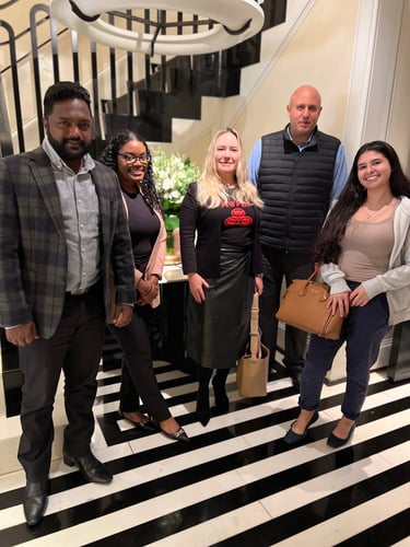 Agent Virginia and four team members standing together and smiling