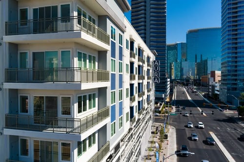 View of a modern apartment building with balconies at Aura Vegas Apartments in Las Vegas