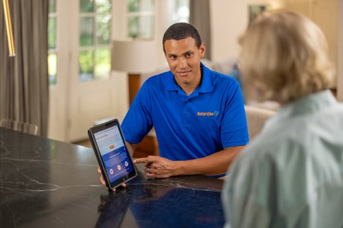 Customer and technician in home going over an estimate