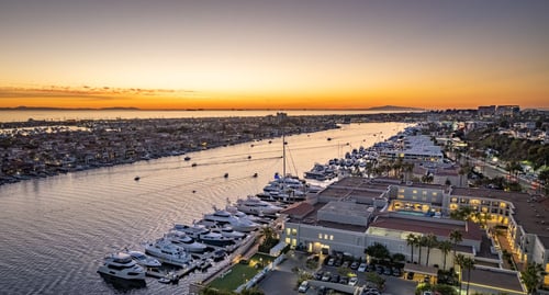 Sunset over a bay filled with docked boats