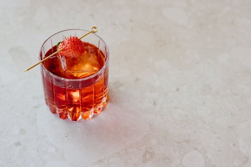 Negroni-style cocktail with strawberry garnish at Salina Rooftop bar in Paso Robles, CA