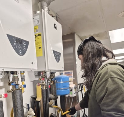 bluefrog Plumber Shae working on a pair of tankless water heaters in a Southwest Portland restaurant.