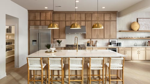 Open kitchens with central islands and plenty of cabinetry for storage