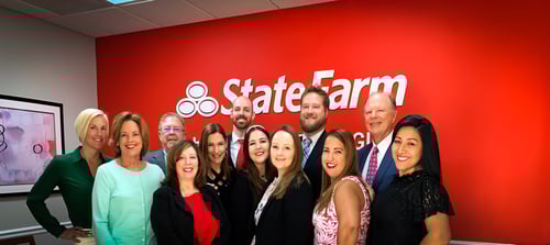 Agent Brian Glaeser and team members standing and smiling together