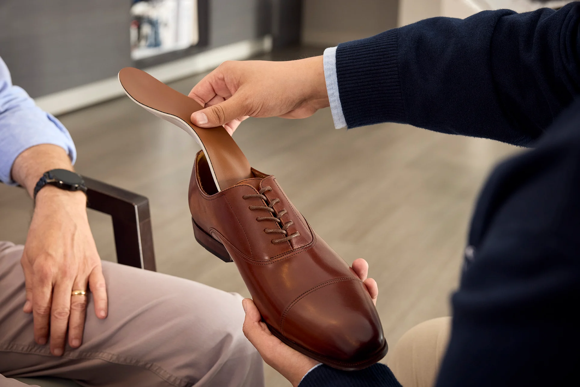 arch support being inserted into dress shoe