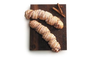 flakey croissant dough filled with cinnamon filling drizzled in icing