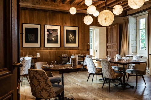 Warm wood and soft light set the stage for intimate, refined dining.