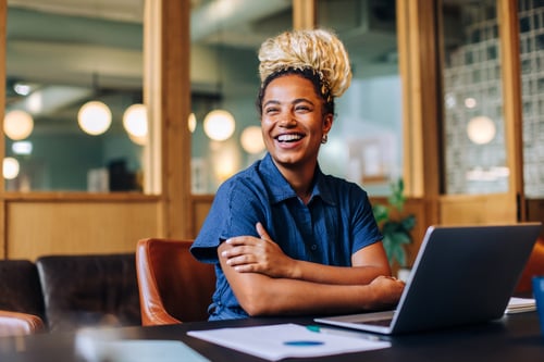 women smiling at a desk