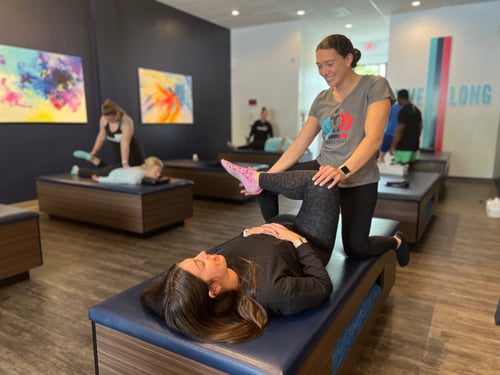 One of our Flexologists, Elizabeth, providing a 1:1 Assisted Stretch session.