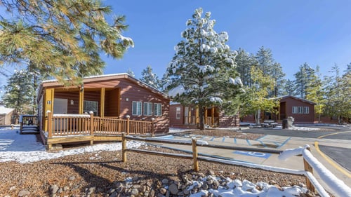 The snow-covered exterior of a cabin at PVC at the Roundhouse Resort.