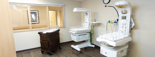 Photo of bassinet and two baby warmers for when baby is being cared for by providers.
