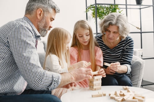 Grandparents playing Jenga with grandchildren