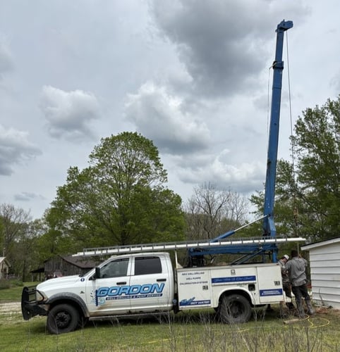 Gordon Well Drilling truck with water well drilling rig on site in Anderson Missouri serving Southwest Missouri and Northwest Arkansas