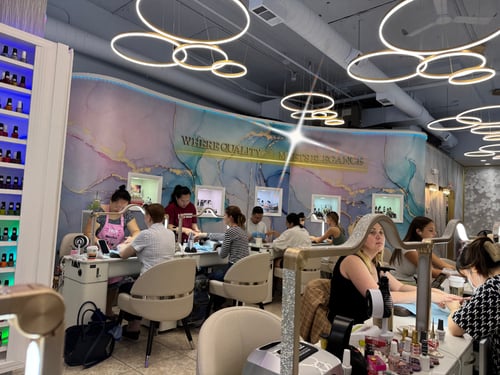 Luxury interior of Premier Nails – Nail Salon Downtown Chicago, featuring elegant lighting, modern nail stations, and the signature wall “Where Quality Meets Elegance.”