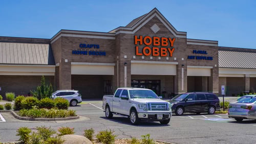 Trucks and vans parked in parking lot of Hobby Lobby Entrance