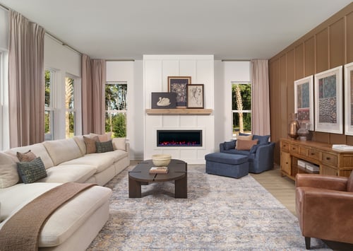 Large living room with oversized sectional and electric fireplace with trim details