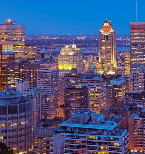 A panoramic view of a vibrant city skyline at twilight, showcasing illuminated buildings, the river, and a glowing horizon.