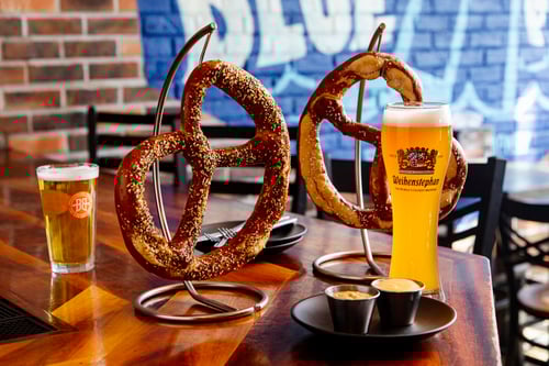 Two pretzels, one with everything bagel seasoning and one regular pretzel