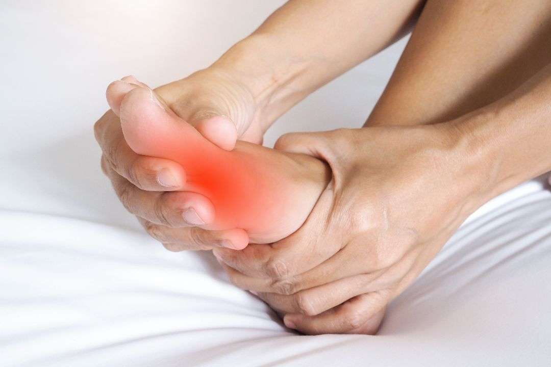 asian people suffering from severe foot pain hands reflexology massage pressure points feet relieve pain
