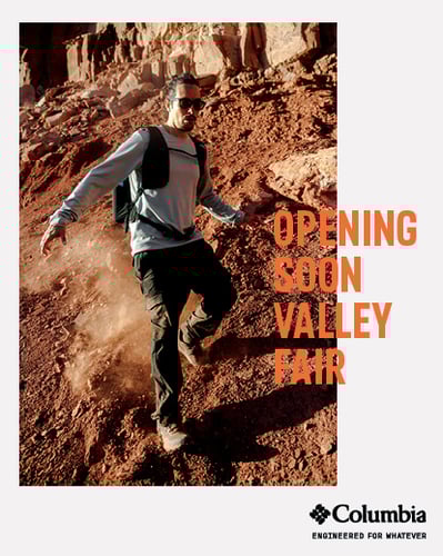 Columbia opening soon at Valley Fair. Man hiking down mountain.