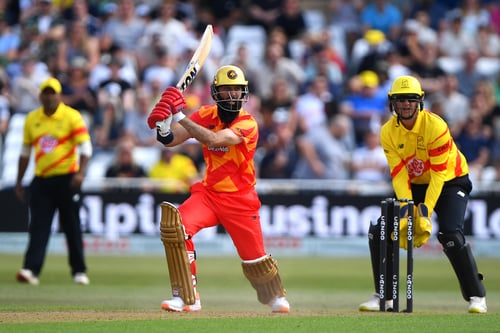Image of batsman and wicket-keeper in action on Cricket pitch.