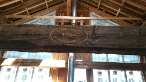 indoor brown hand carved wooden beam sign