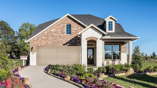 single-family home with floral landscaping and stone exterior