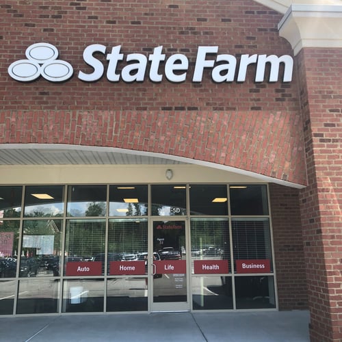 Brick building with white State Farm sign