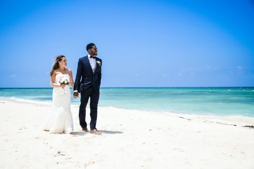 Wedding couple walking on the beach near The Thunderbird Beach Resort