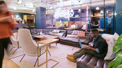People working in a shared office space at WeWork