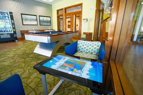 Infinity Game Table with a pool table in the background.
