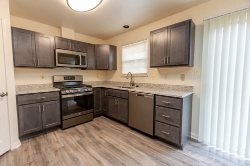 Kitchen with a refrigerator freezer and a stovetop oven at Carlson Woods Townhomes, Baltimore, Maryland
