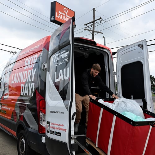 Speed Queen Laundry Pick Up and Delivery service van being loaded with laundry