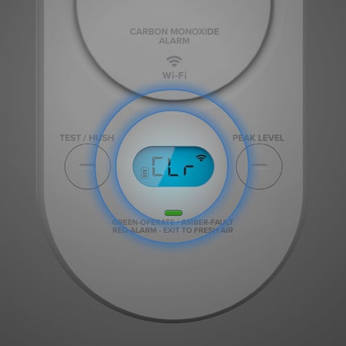 A CO alarm with the display lit and circles highlighting the screen.