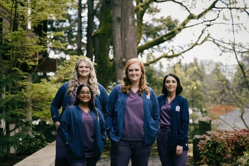 Pediatric dentistry team with a forest backdrop