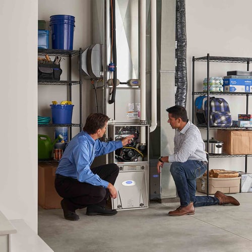A Carrier dealer discusses furnace repair and service with a homeowner